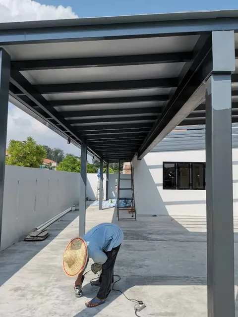 Installer at work under a new ACP awning