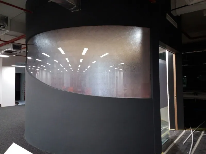 Curved frosted polycarbonate wall in an office