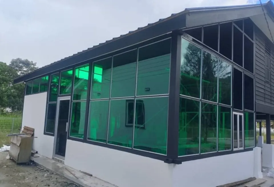 Building extension with green tinted polycarbonate walls