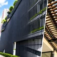 Building with aluminium louvre screens and a wood grain pergola